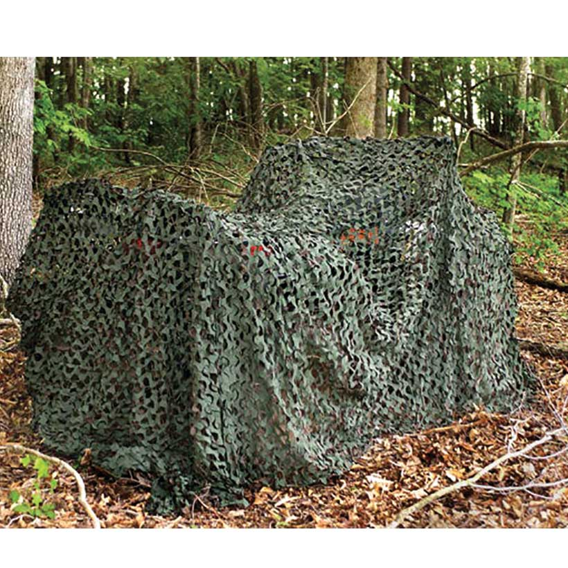 Outdoor camouflage netting deployed in a natural environment